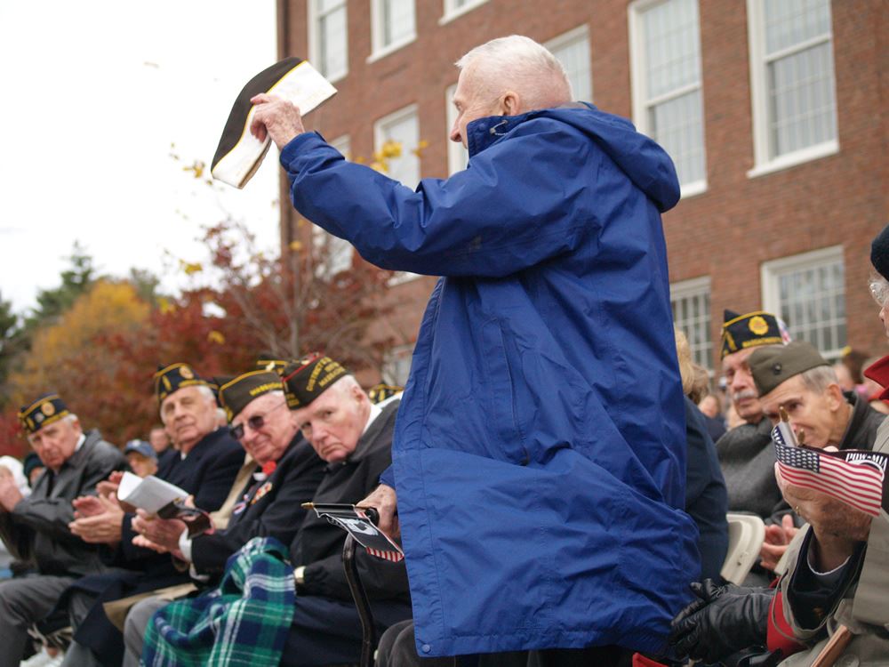 Veteran holding hat